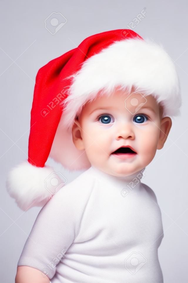 Beautiful baby with Christmas hat isolated in white