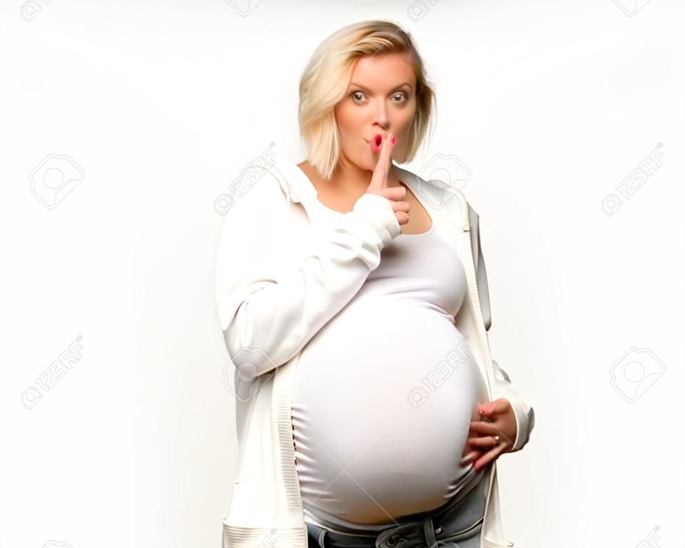 Schwangere blonde Frau mit weißem Sweatshirt, die ein Zeichen des Schließens des Mundes und der Schweigegeste auf isoliertem grauem Hintergrund zeigt