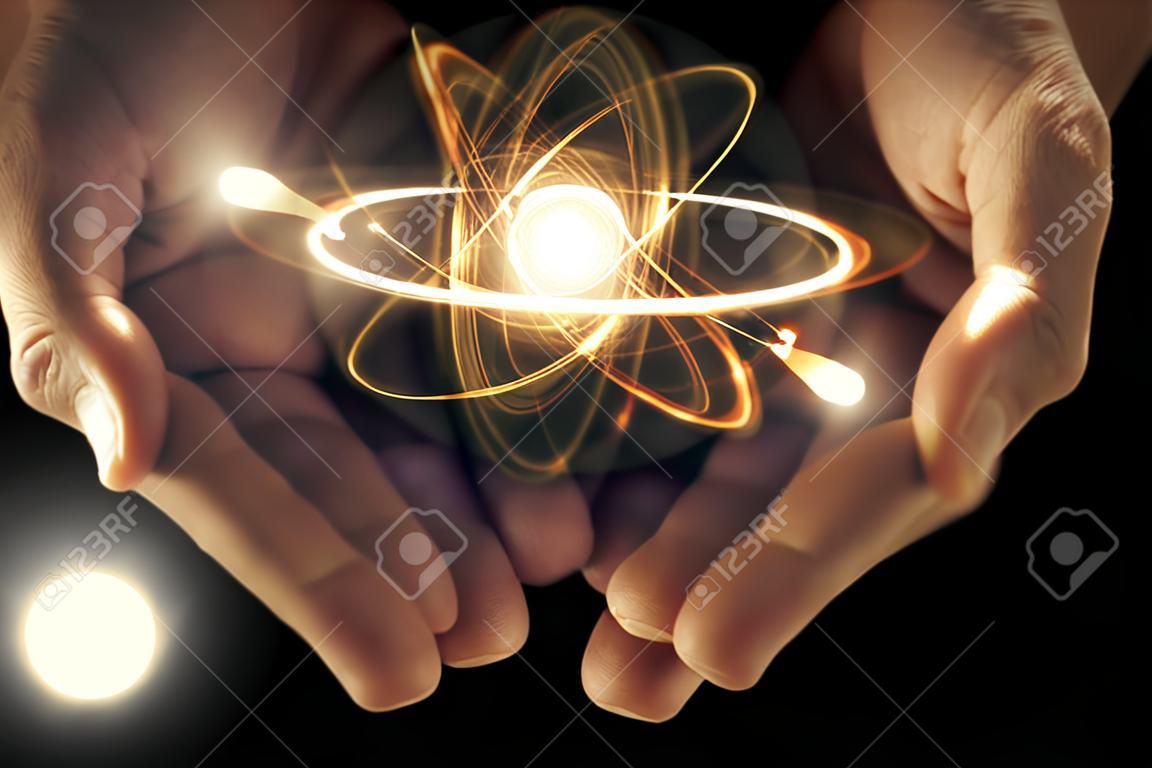 Partícula orbitting Atómica que se celebra en las manos ahuecadas