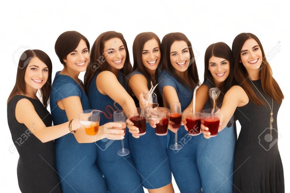 A portrait of seven girlfriends in party moods smiling and drinking over white background