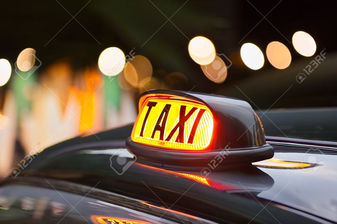 neon sign of a London taxi car at night