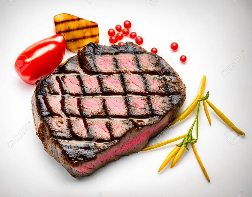 grilled beef steak with spices isolated on white background