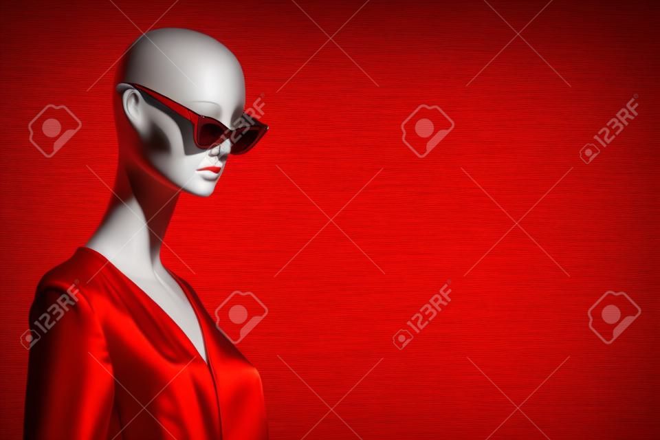 Retrato de maniquí femenino con gafas de sol y vestido rojo. Tema de venta y publicidad. Copyspace para texto