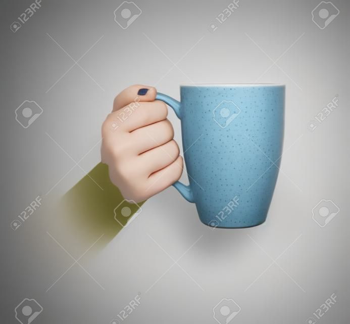 the girls hand is holding a mug. Side view.