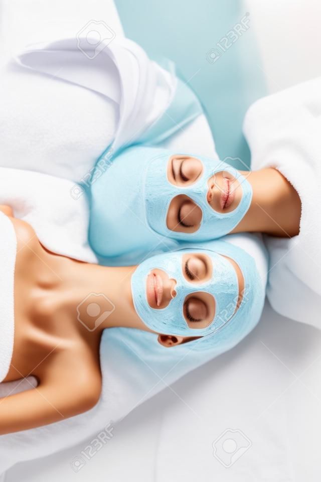 Spa. Group woman getting facial mask and gossip