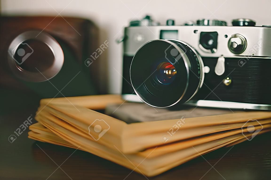 Retro vintage camera and photo frames on wood table