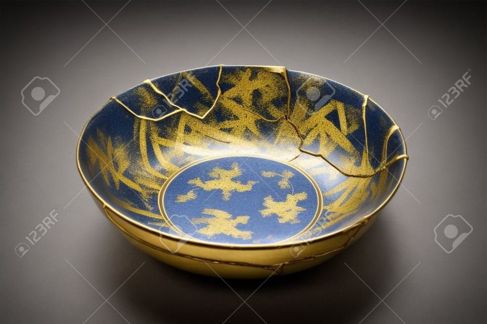 Kintsugi tea ceremony bowl. Gold cracks restoration on old Japanese pottery restored with the antique restoration technique The unique beauty of imperfections.