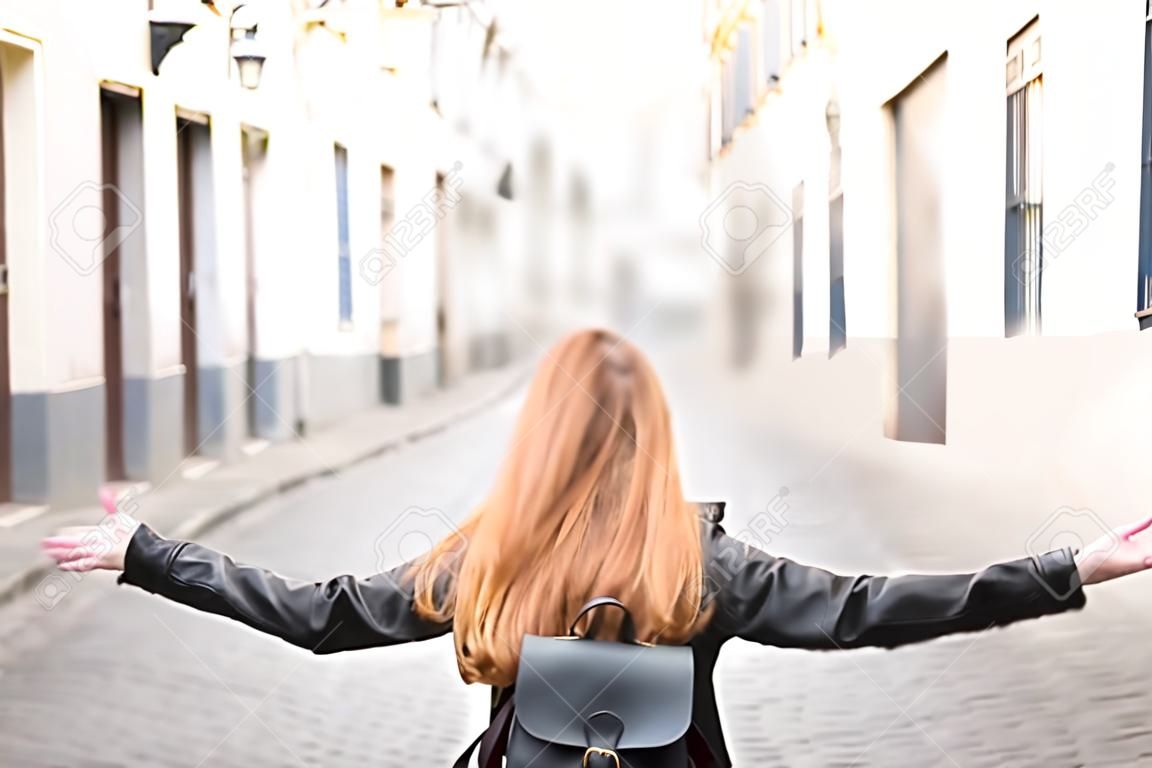 Redhead student girl enjoying freedom in city