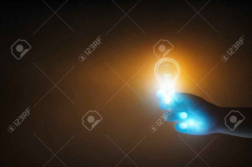 Hand of man holding light bulb. Concept of inspiration creative idea thinking and future technology innovation