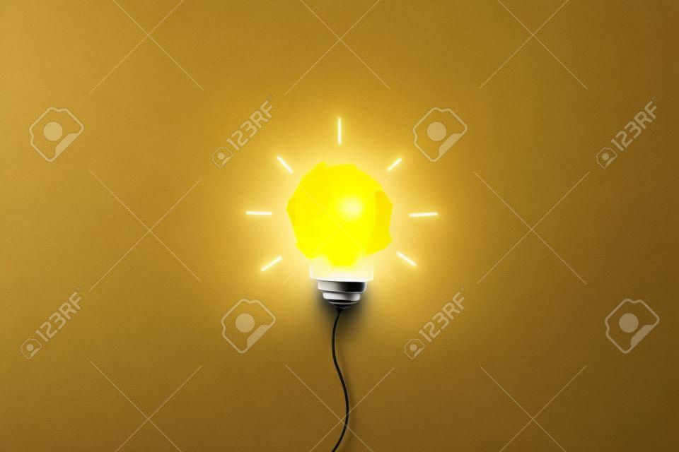 Creative thinking ideas and innovation concept. Paper scrap ball with light bulb symbol on yellow background