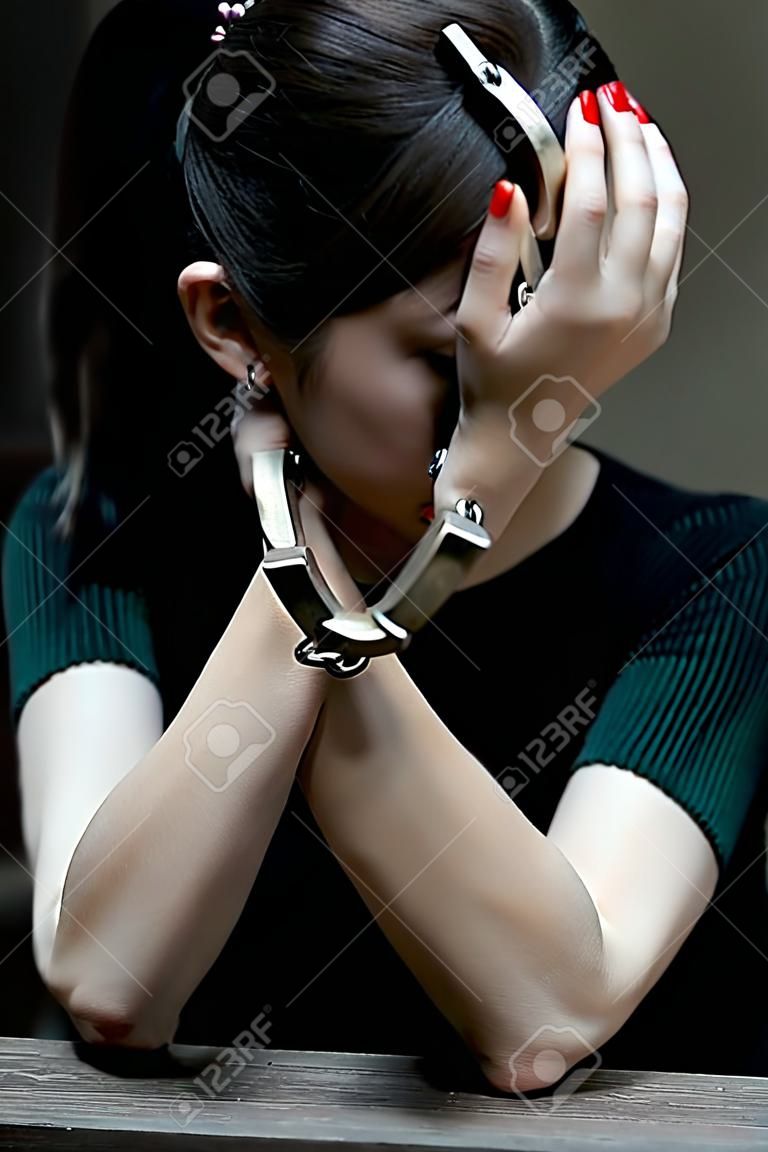 Handcuffed on a prisoner, Woman prisoners were handcuff in the dark prison.