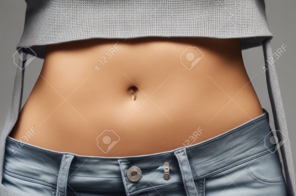 Close up photo of woman slim belly.