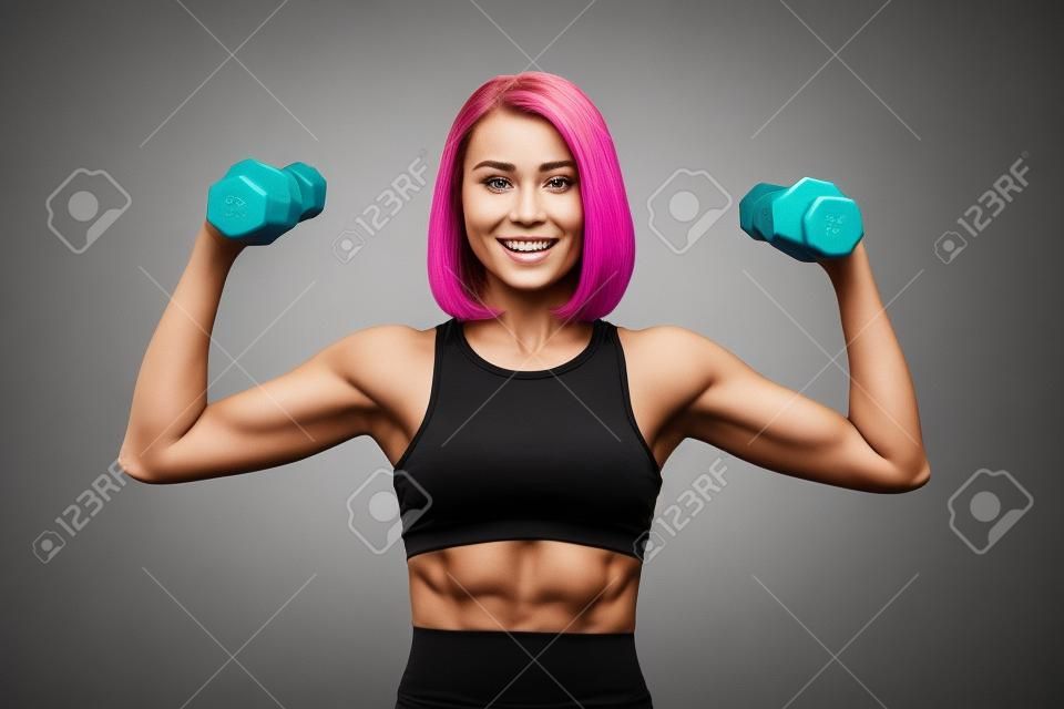 Woman is exercising with dumbbells