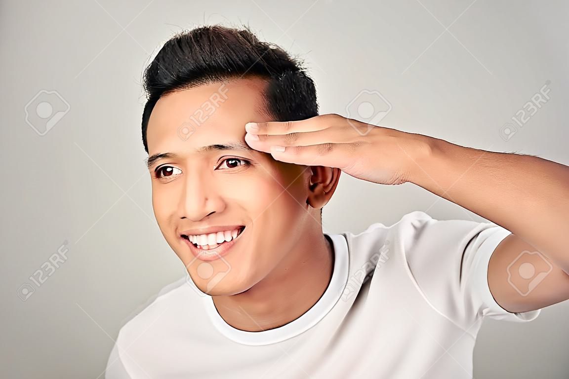 Handsome man touching his face close up portrait studio on white background
