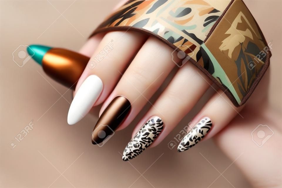 Luxe veelkleurige beige bruine manicure met dierlijk ontwerp op lange nagels.