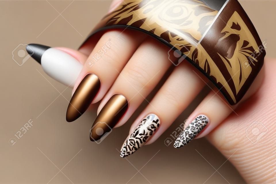 Luxurious multicolored beige brown manicure with animal design on long nails.