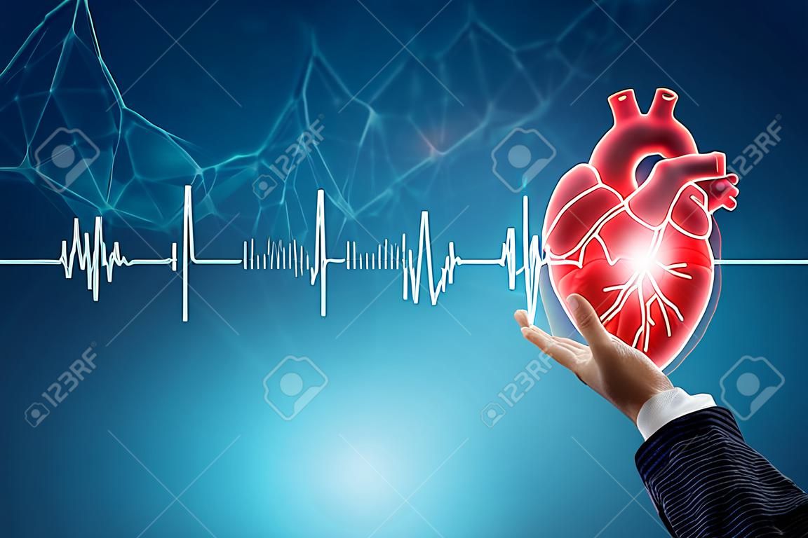 Hologramme du coeur humain dans la main et ligne de cardiogramme. Le concept de transplantation, don, organe, don, charité, santé
