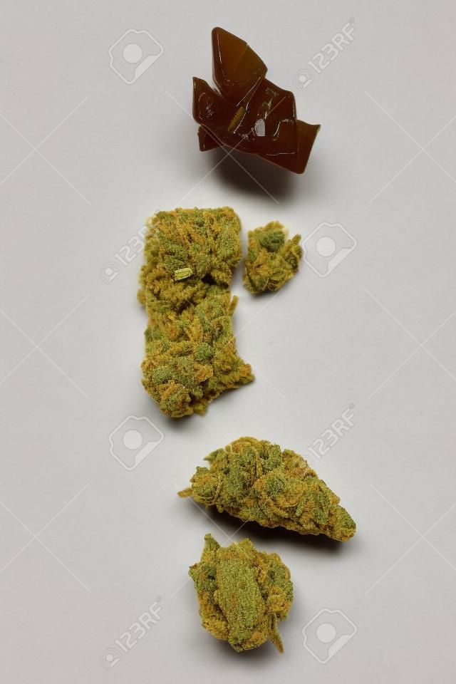 Cannabis bud, crumble, shatter concentrate on white background. Marijuana concentrates.