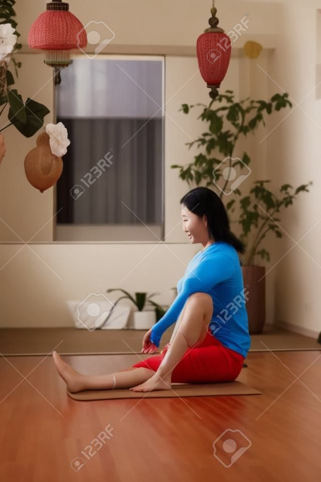 Asian woman stretching in the room