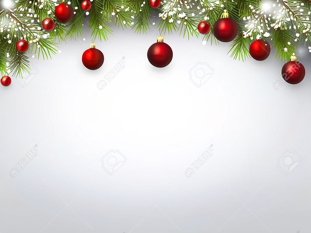 Fond de Noël avec des branches de sapin et boules rouges.