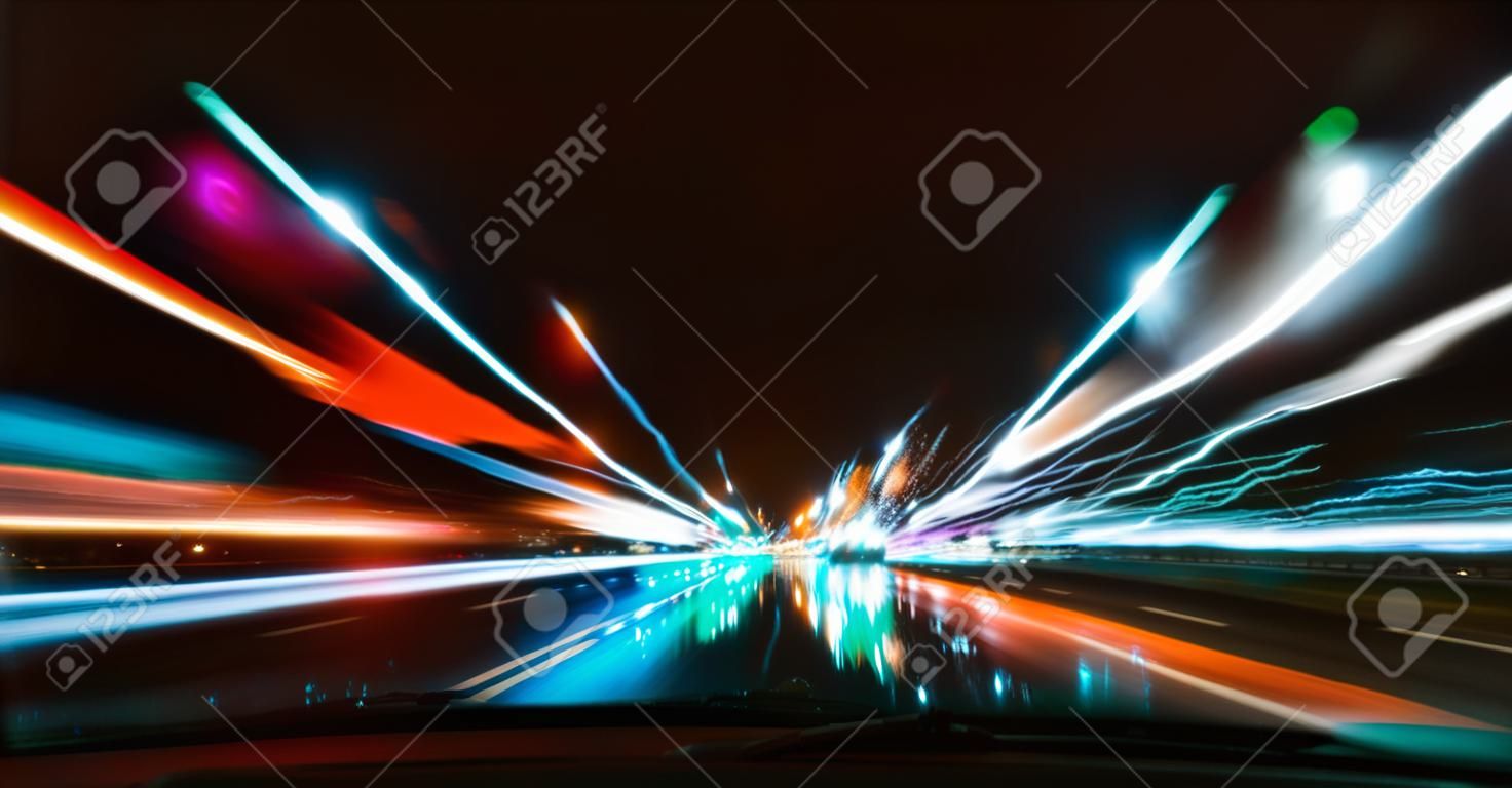 Night driving.Long exposure photo.City colorful night lights perspective blurred by high speed of the car.