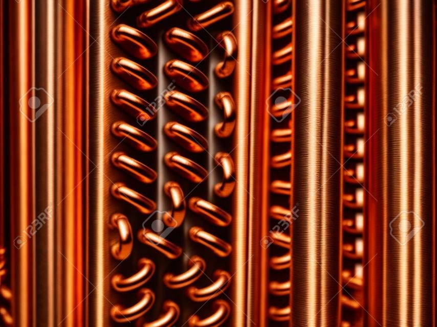 Close up shot of copper tubes of a condenser coil.