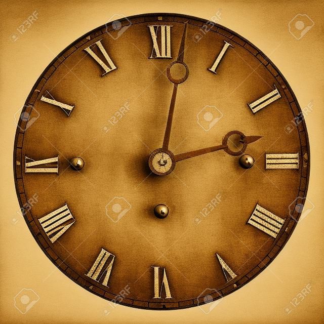 Sepia toned image of an old clock face isolated on a white background