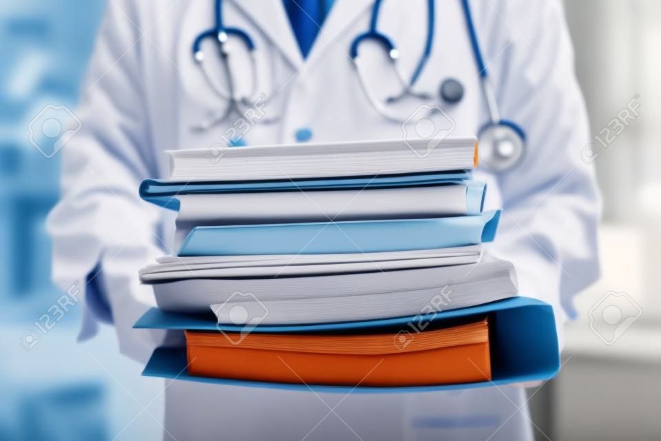 Doctor is holding large stack of folders. Disease history concept