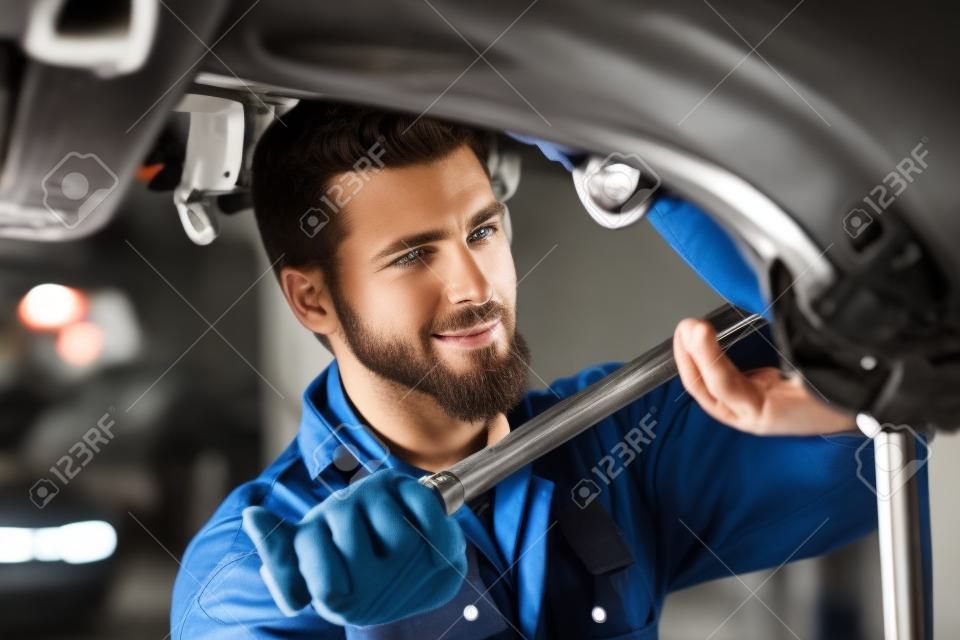Handsome car mechanic at work