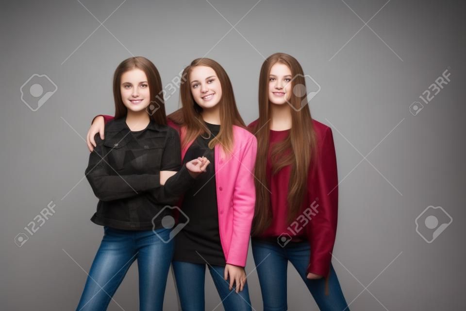 Studio portrait of young attractive caucasian teen girls posing at studio