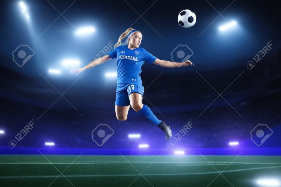 Young female soccer or football player in blue sportswear and boots kicking ball in jump at the stadium in flashlights, spotlights. Concept of professional sport, hobby, motion, movement. 3D render.