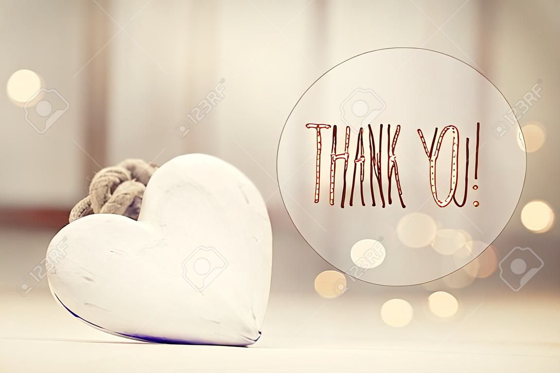 Thank You message with a white heart  in a room
