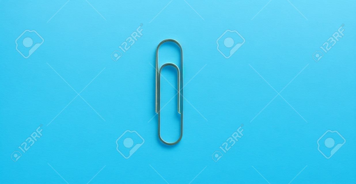 Big paper clip on a bright blue background