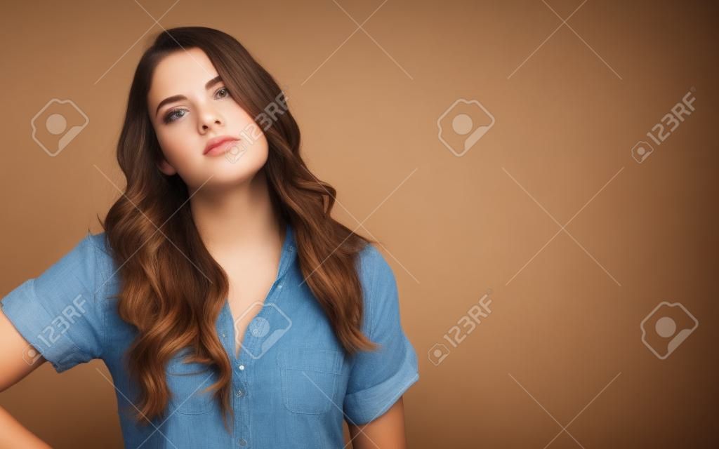 Bored young woman on a solid background