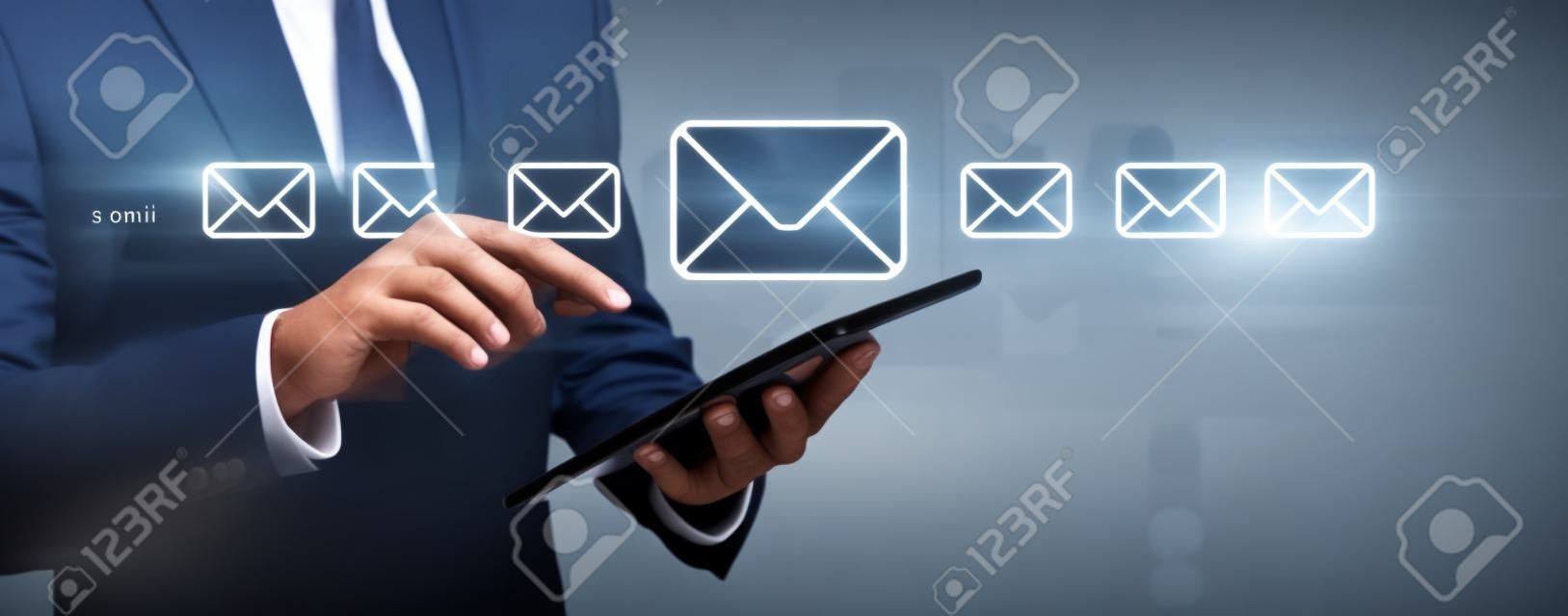 Email concept with businessman using his tablet computer