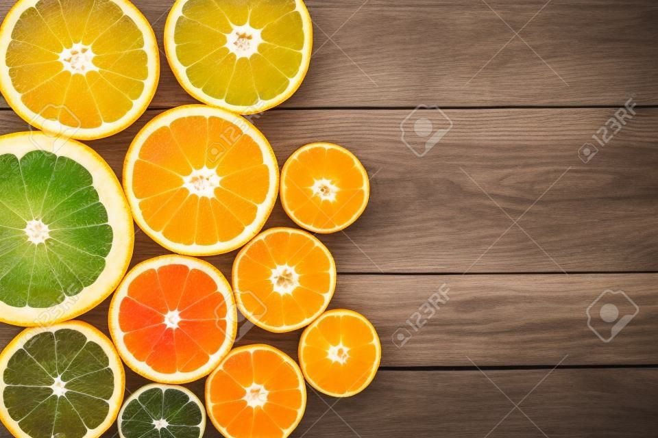 fresh citrus half cut fruits overhead on wooden table
