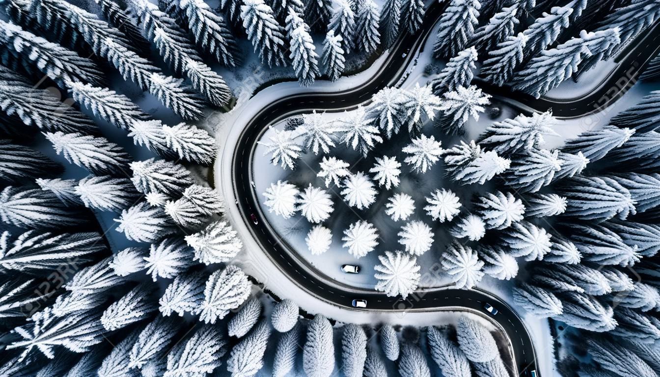 Curvy road line in winter scenery, aerial view.