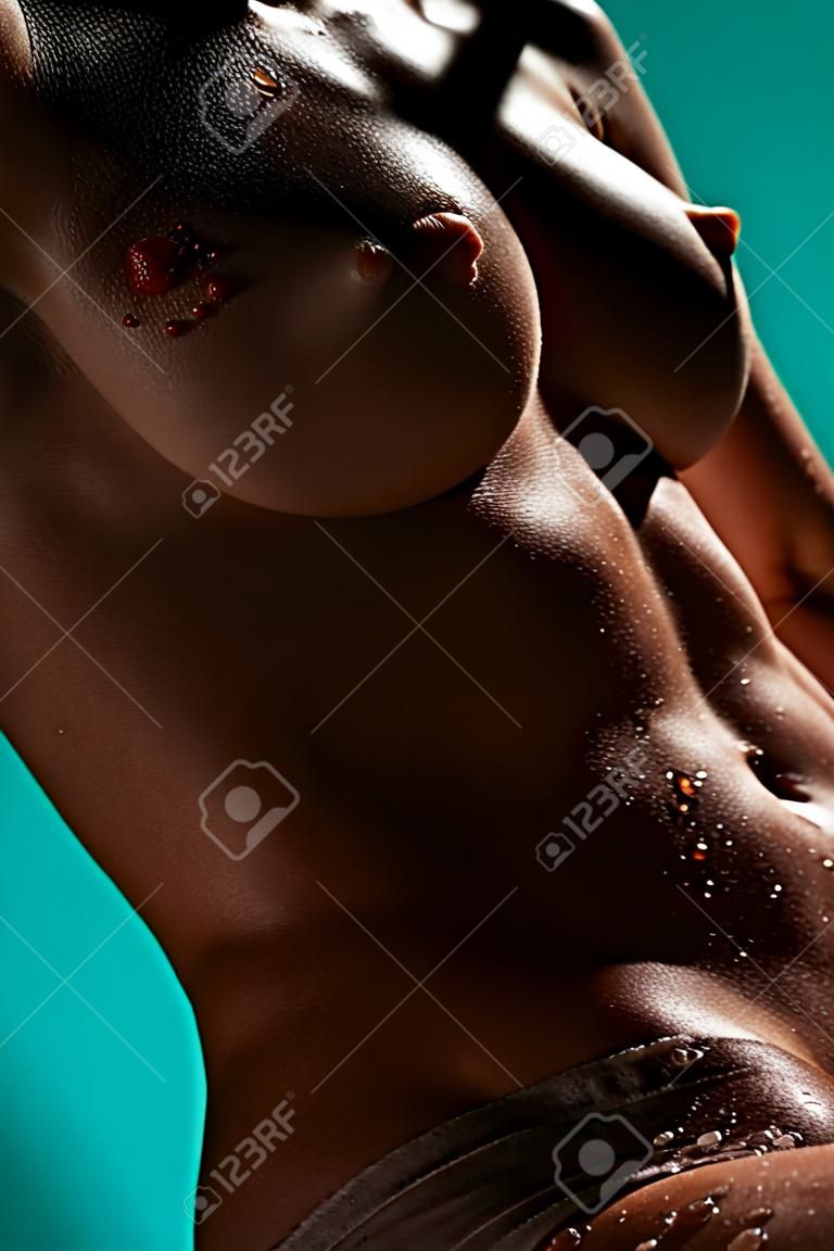 Beautiful female body with drops of water