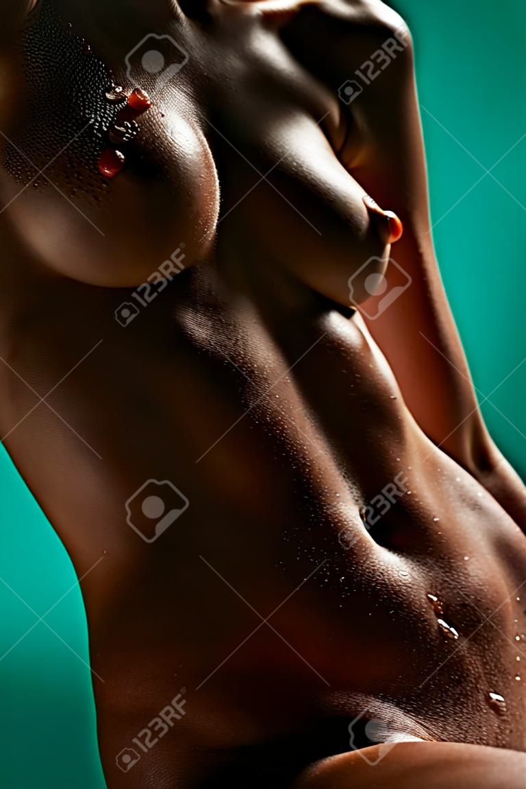 Beautiful female body with drops of water