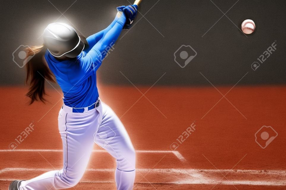 A Female Baseball Player is Batting Swinging at the Pitch