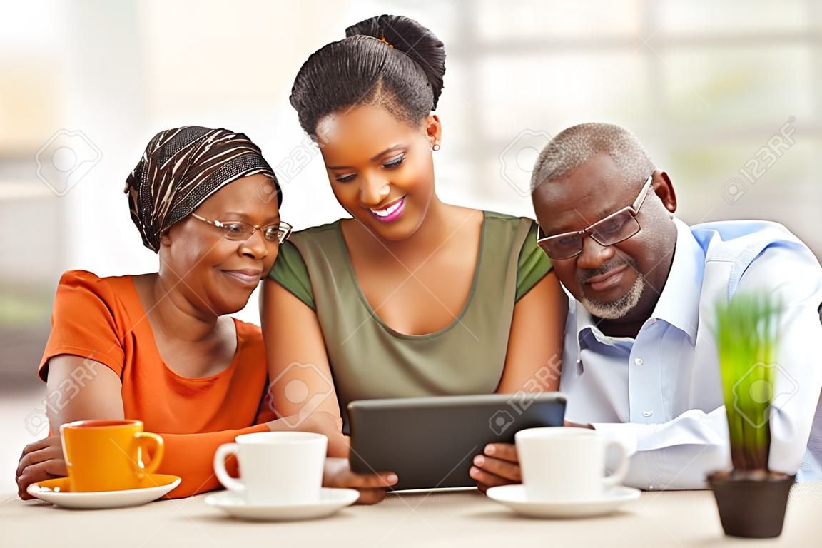 joyeuse famille africaine à la maison en utilisant Tablet PC