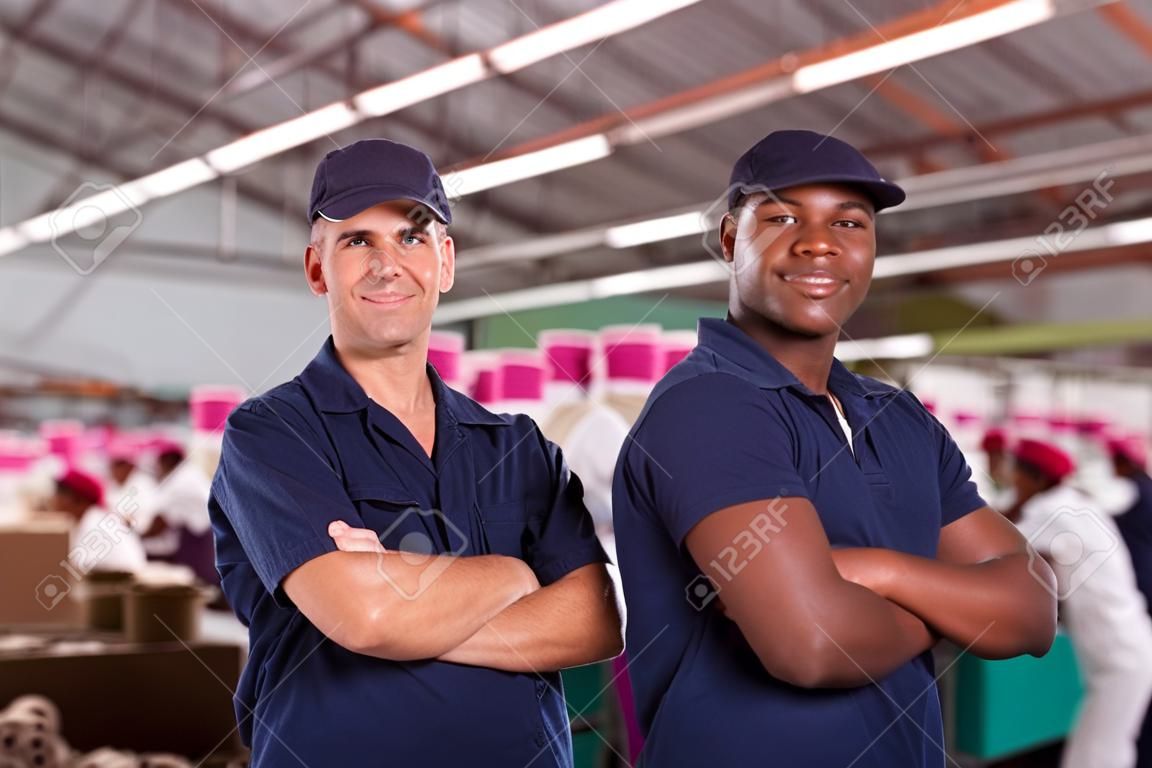 portrait of happy textile factory workers with arms crossed