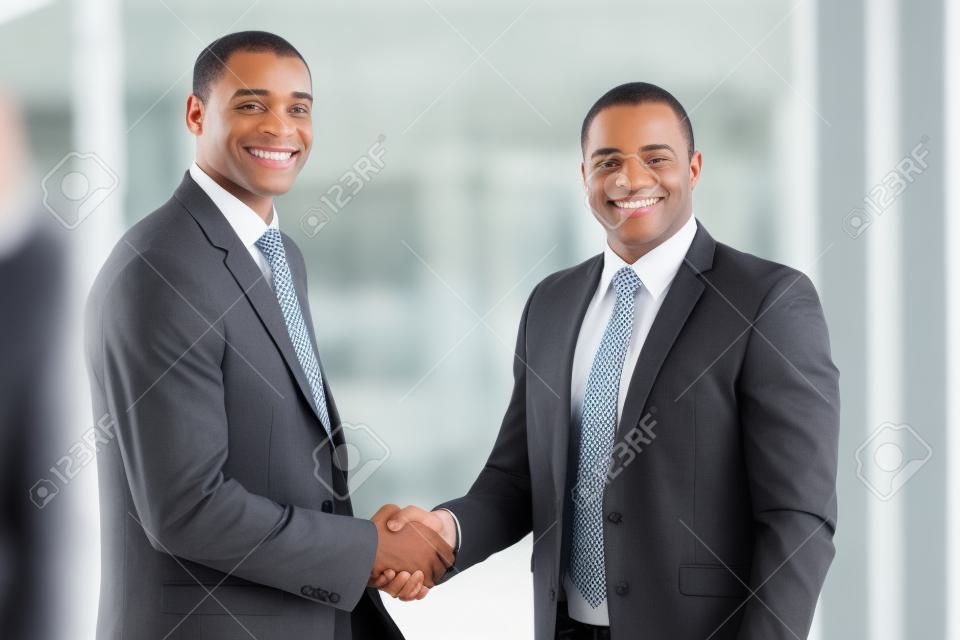 portrait of happy african american businesspeople handshaking