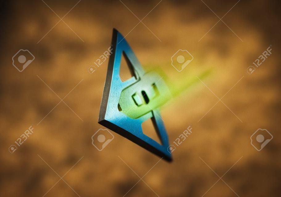 Shallow depth of field image of an arrow flying in the direction of the viewer.