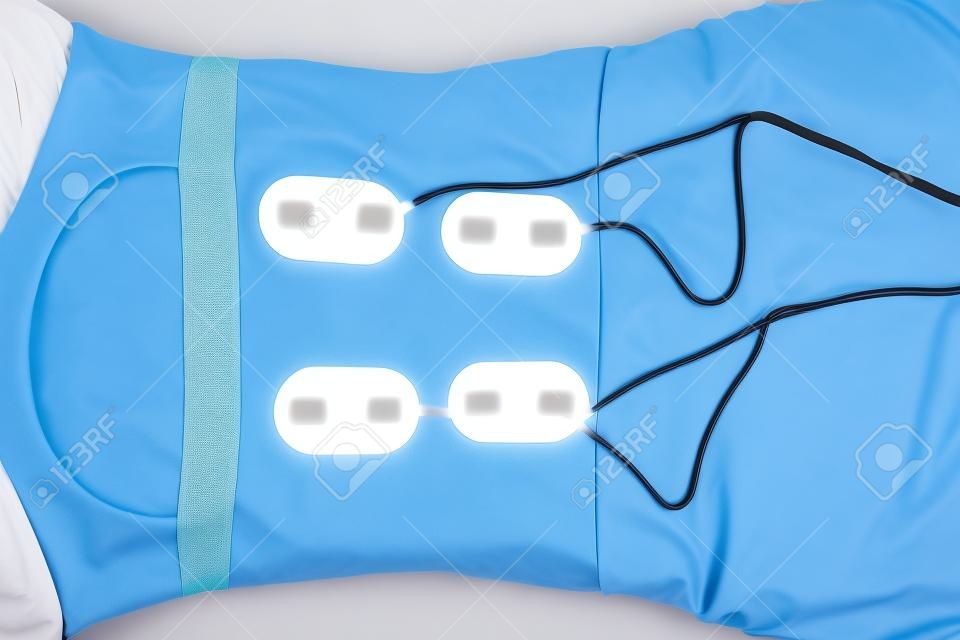 Lower Back Physical Therapy with TENS Electrode Pads, Transcutaneous Electrical Nerve Stimulation. Electrodes onto Patient's Lower Back