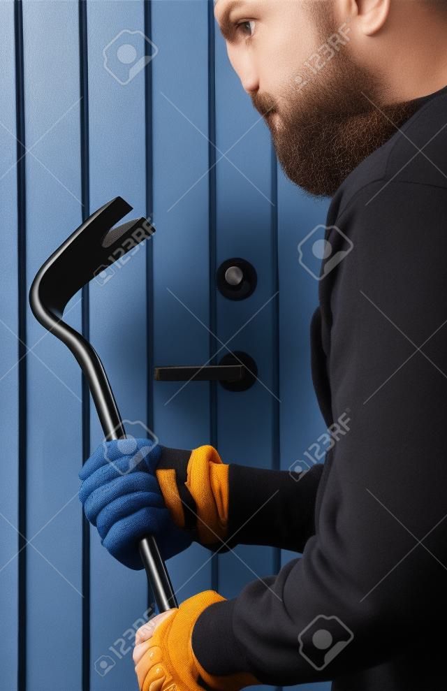Burglar hand holding crowbar 