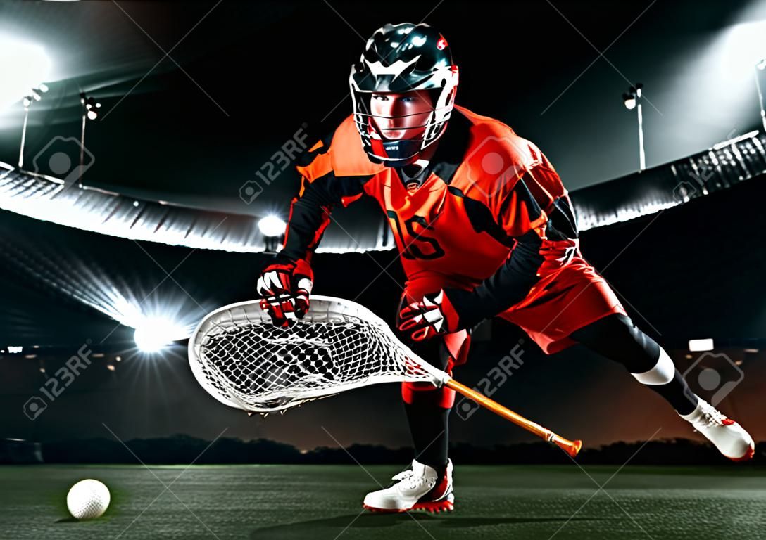 Gracz lacrosse, sportowiec sportowiec w czerwonym kasku na tle stadionu. tapeta sportowa i motywacyjna.