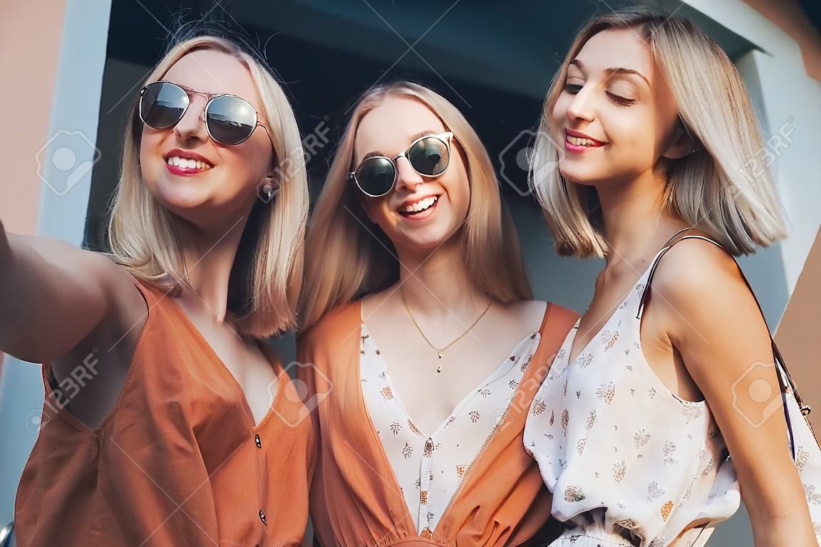 three beautiful young girls on vacation in a dress and glasses. Generative AI.
