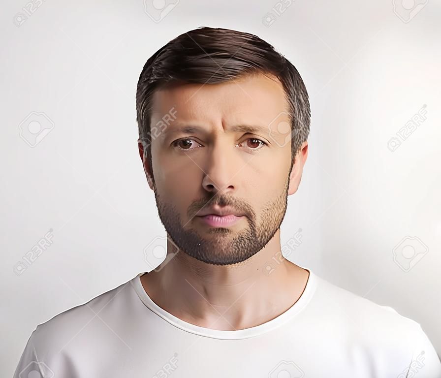Passport Photo. Portrait Of Middle Aged Man Looking At Camera Over White Studio Background. Isolated