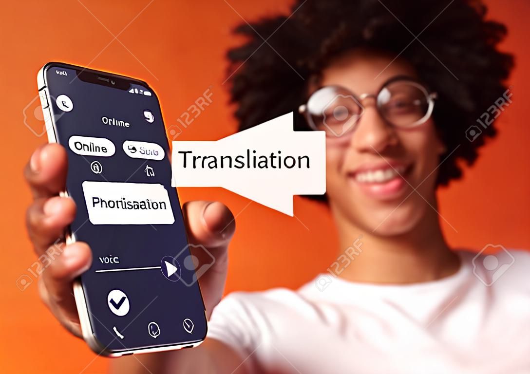 Cheerful Black Guy Showing Smartphone With Opened Voice Translation App On Screen, Using Online Translator In His Cellphone, Standing Over Orange Studio Background, Creative Collage, Closeup
